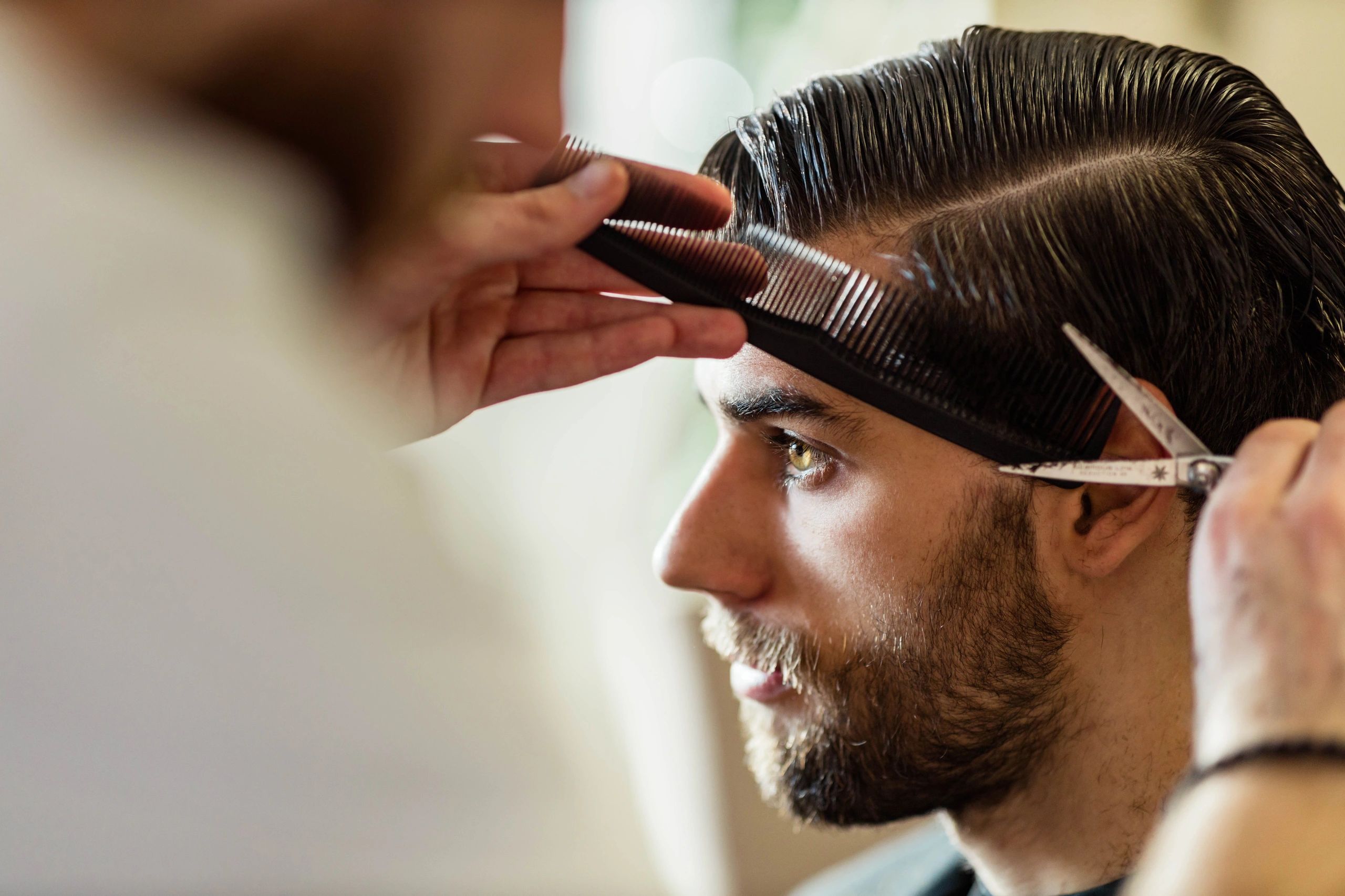 Mobile barber giving a haircut during an at-home appointment