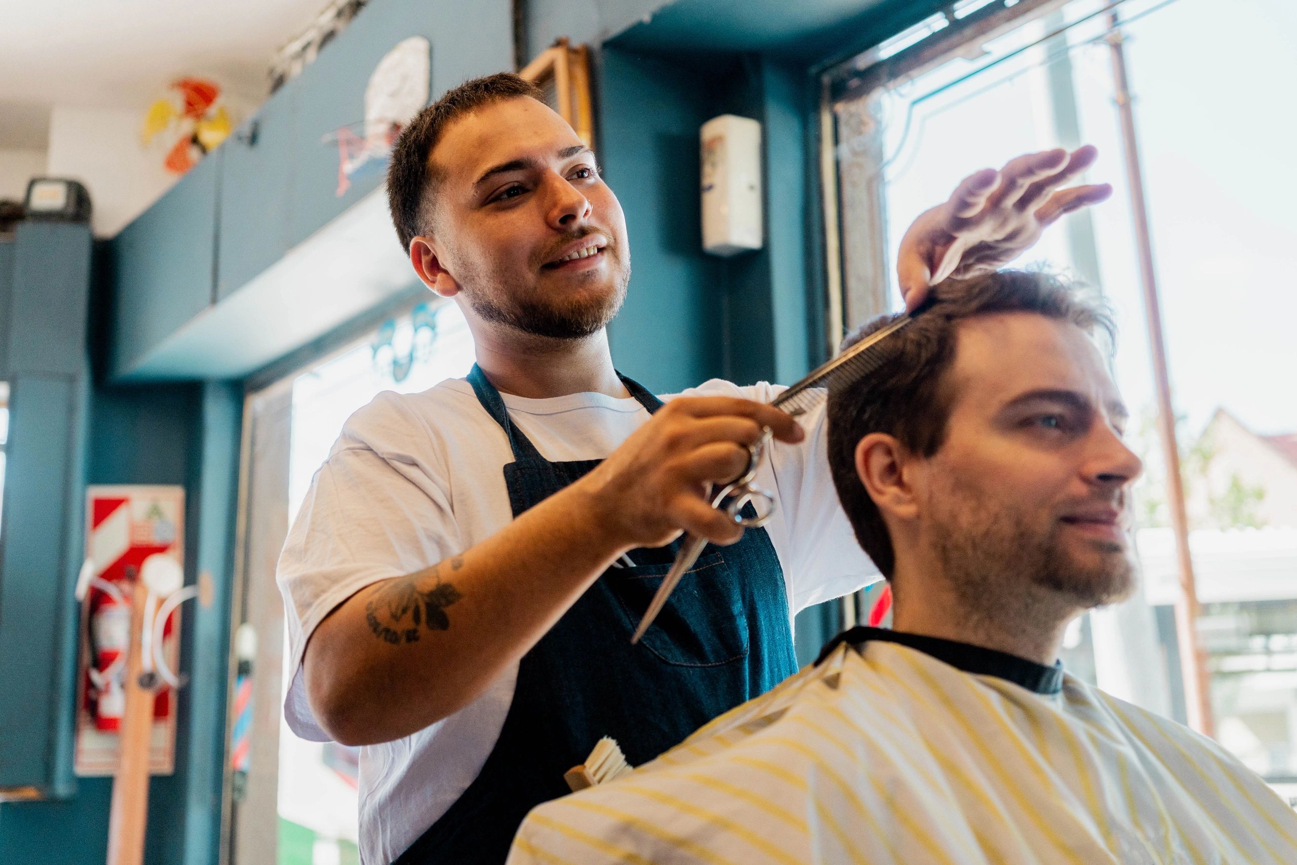 Barber cutting a client's hair during a grooming appointment