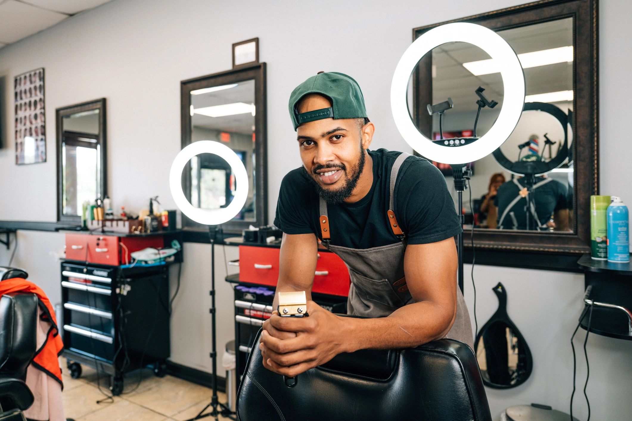 Barber holding clippers ready for a grooming service