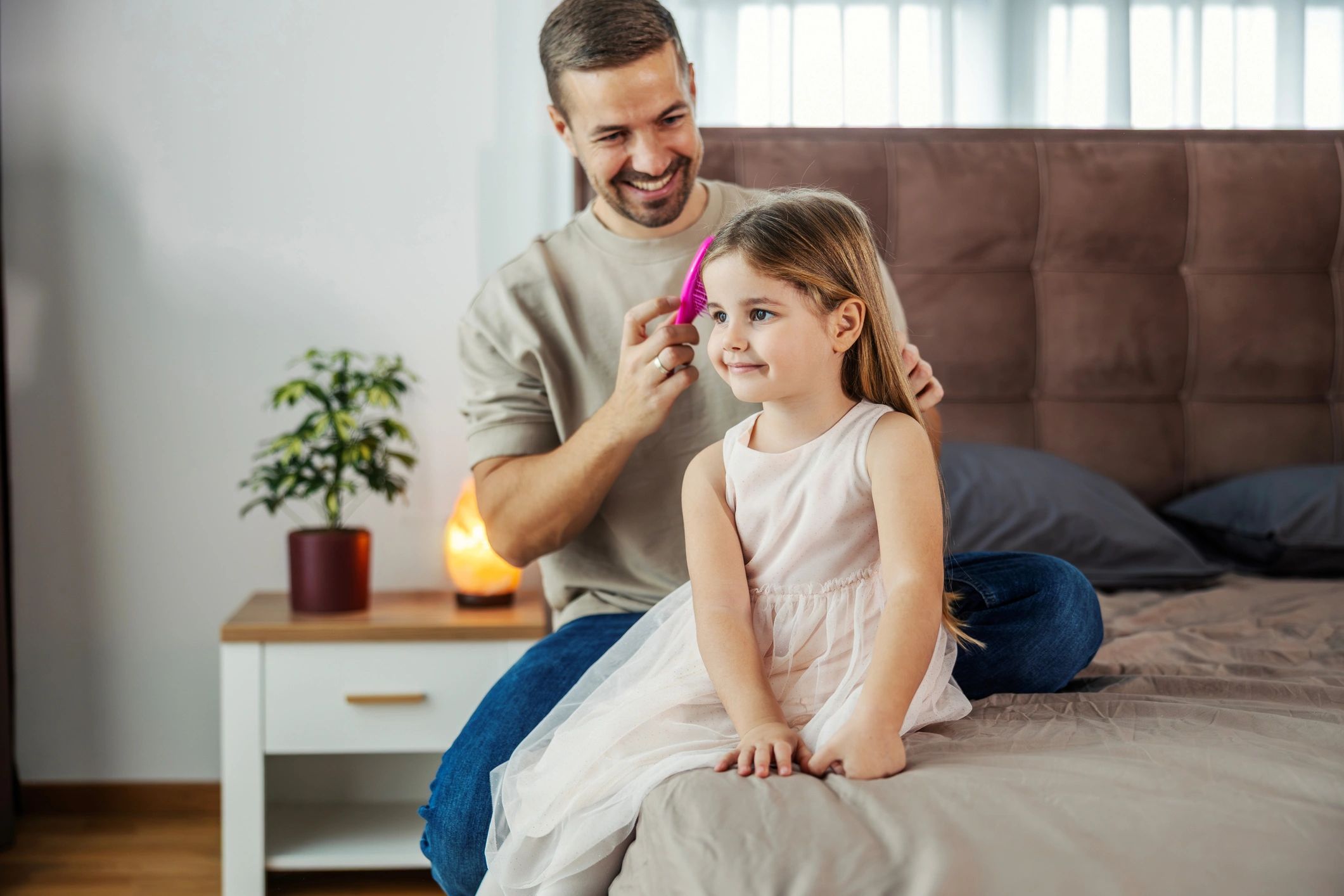 Parent helping a child with hair at home